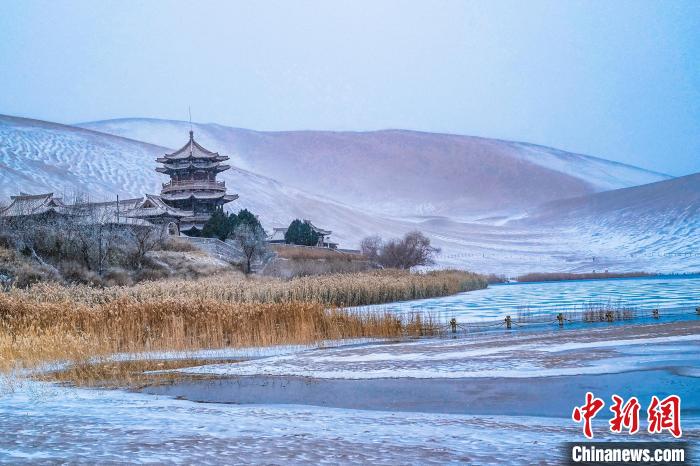 2021年11月28日，雪落鳴沙山月牙泉景區(qū)。　王斌銀 攝