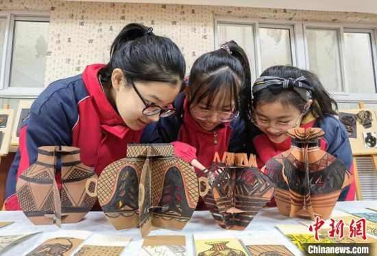 圖為學(xué)生用紙創(chuàng)作的立體彩陶?！⒂裉?攝