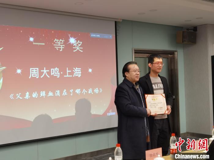 圖為作家、西北師范大學新聞與傳媒學院院長徐兆壽頒發(fā)一等獎證書，代領獎者上臺領獎。　楊娜 攝