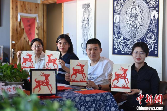 6月6日，在甘肅敦煌青年夜校課程中，青年學(xué)員展示學(xué)習(xí)敦煌非遺剪紙的成果。李亞龍 攝　　